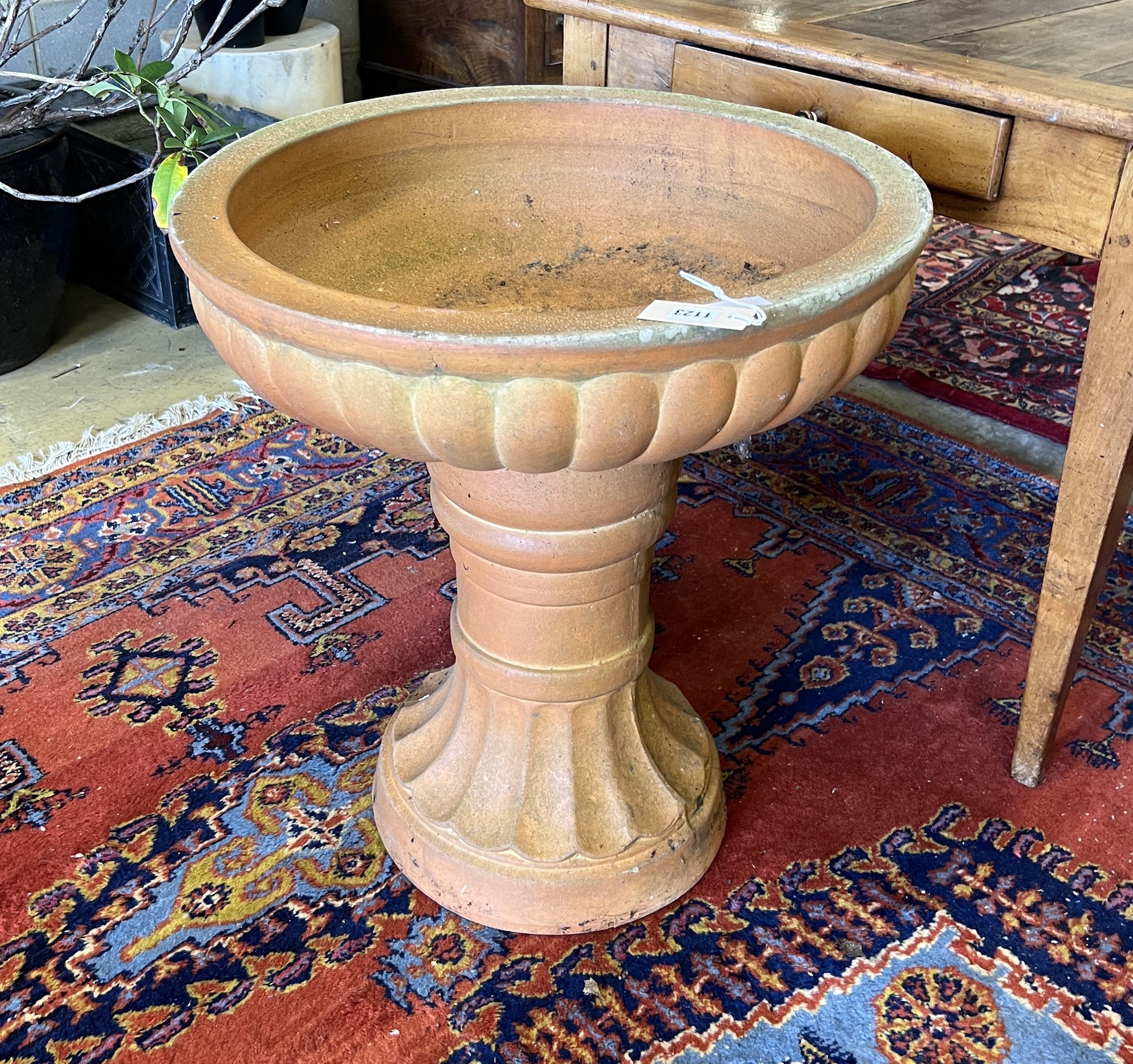 A circular terracotta garden planter, diameter 60cm, height 67cm